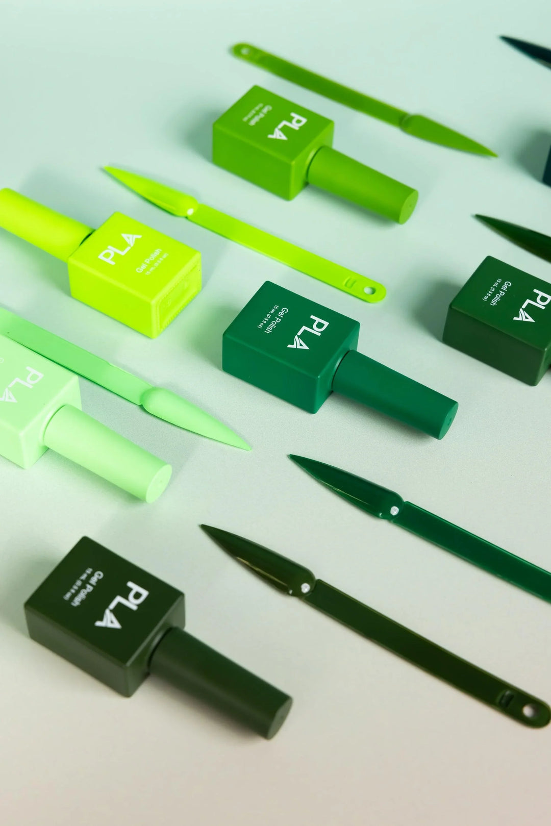 Mini nail polish sets from Paris Lash Academy — Greens (gel polishes, laying down out of box, with color swatch)