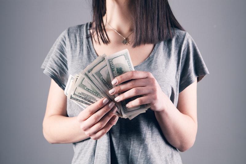 Money Saving Hack For Lash Artists And Nail Techs, lady holding cash close up