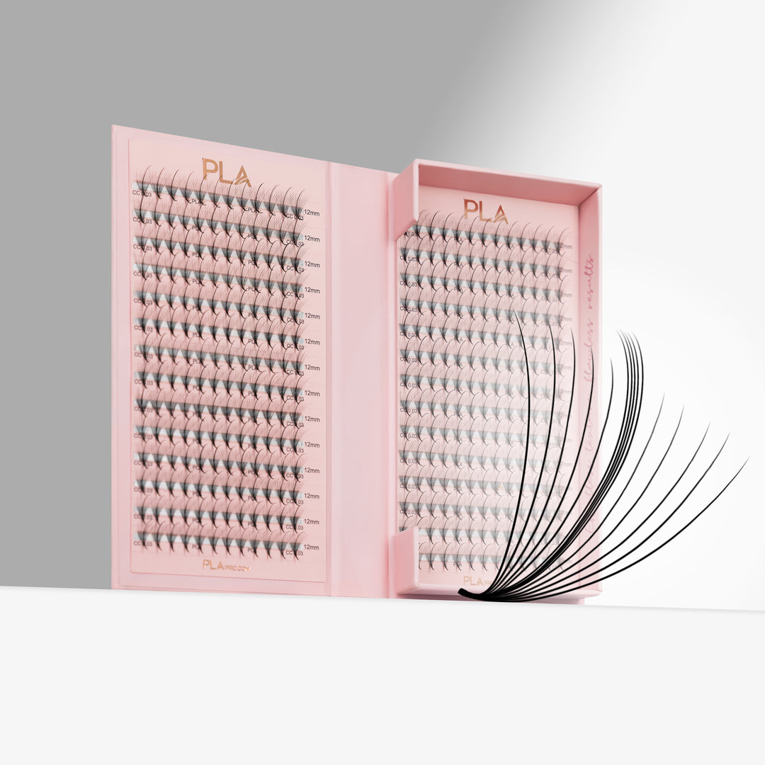 Pink tray of eyelash extensions displayed on a white surface against a gray background, with a close up promade fan extending from the right of the tray. The brand name PLA is visible on the tray.