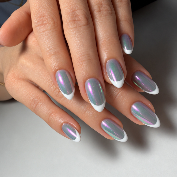 Almond-shaped nails with white French tips and an iridescent chrome finish reflecting pink, purple, and green.