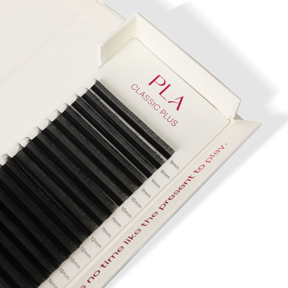 A close-up of a tray of black eyelash extensions labeled PLA CLASSIC PLUS, with size measurements printed along the side of the packaging.
