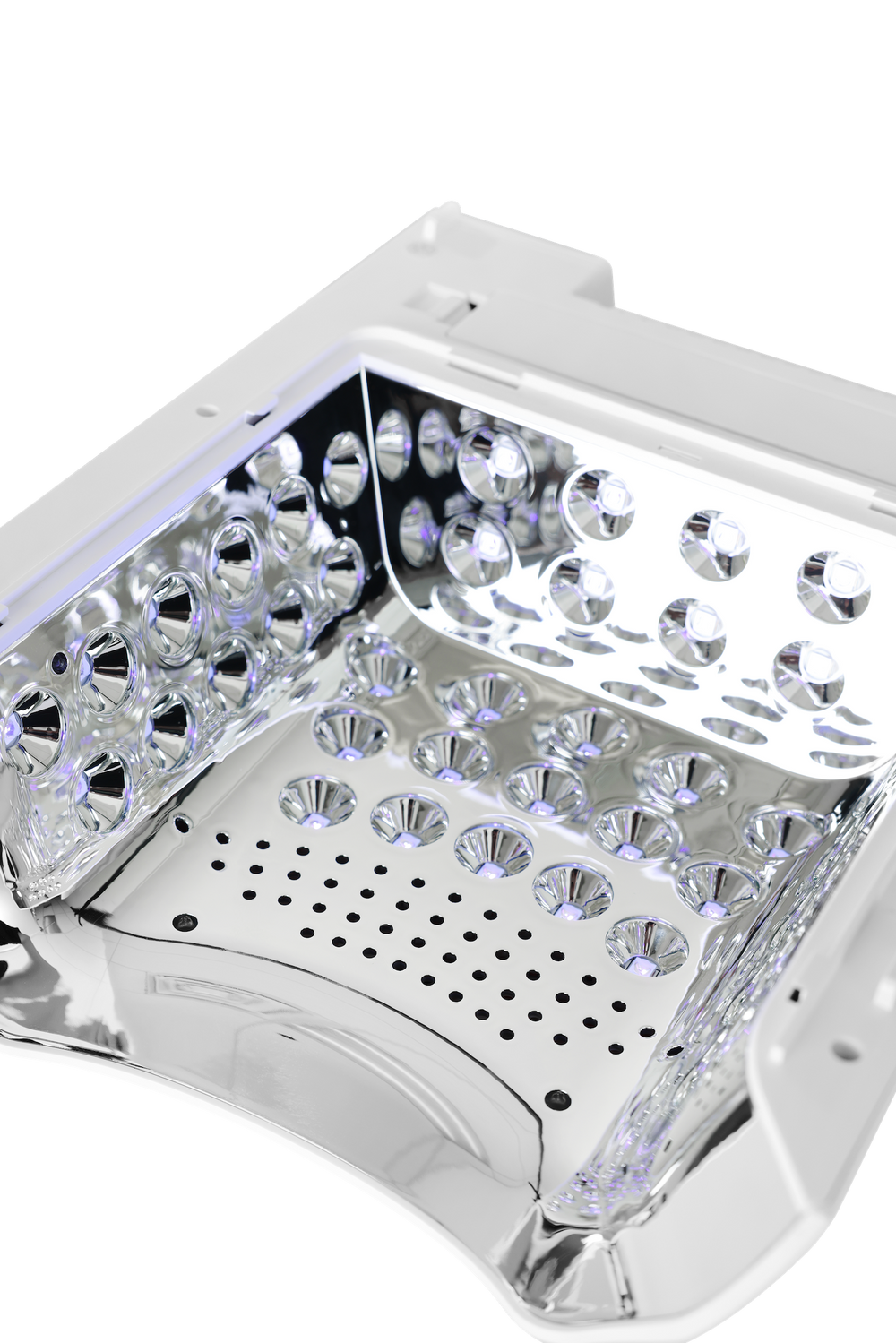 Close-up of a white and silver LED light therapy panel showing the interior with multiple clear faceted crystal prisms and a perforated metal plate.