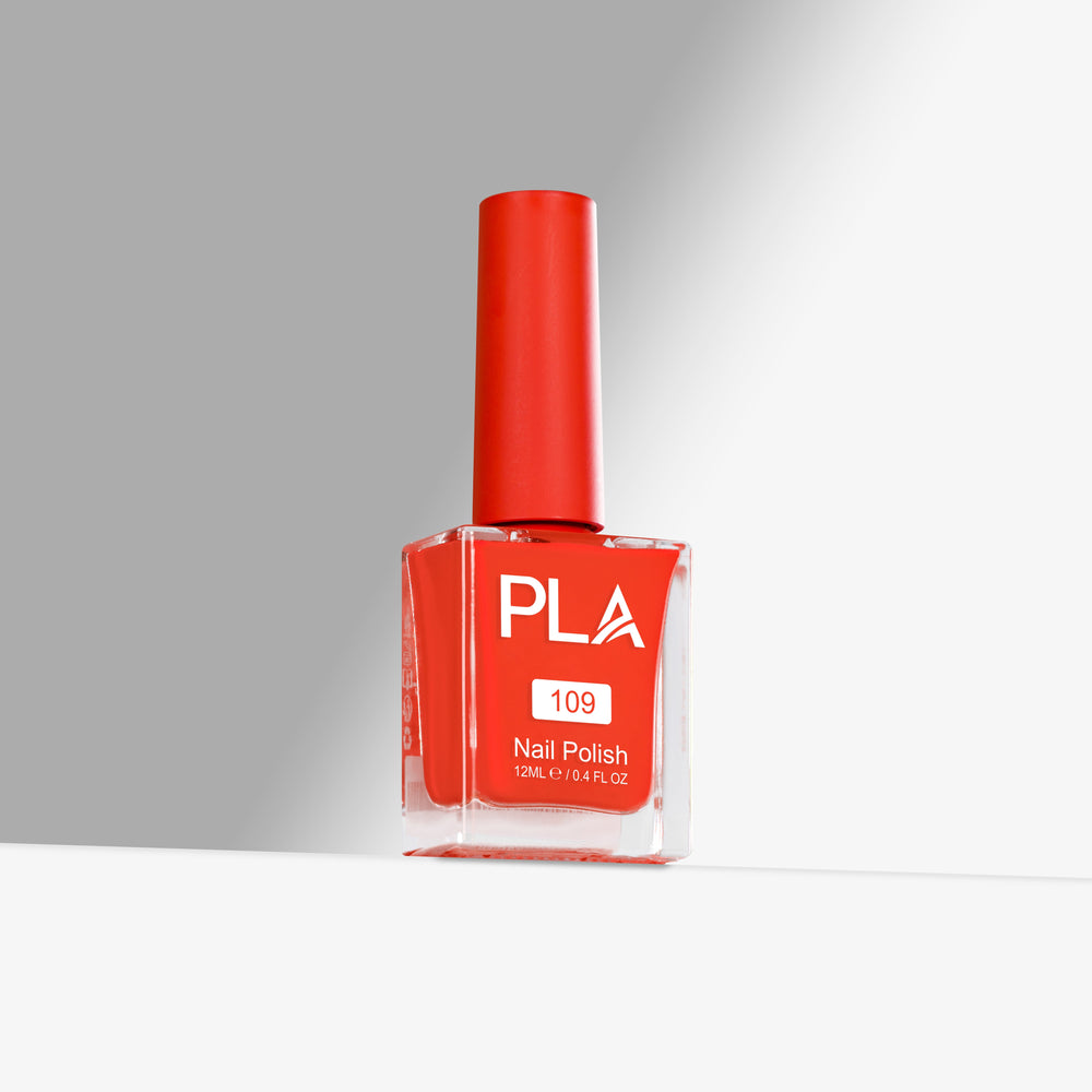 Red nail polish bottle with 'PLA' branding on a gray background