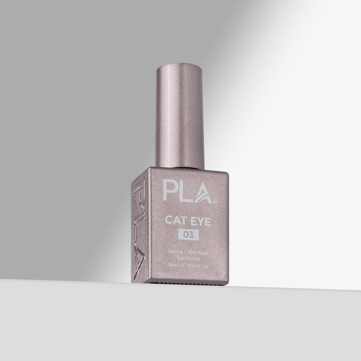 A bottle of PLA Cat Eye gel nail polish in shade 03, featuring a light pink bottle and cap, set against a clean gray studio background with a spotlight effect.