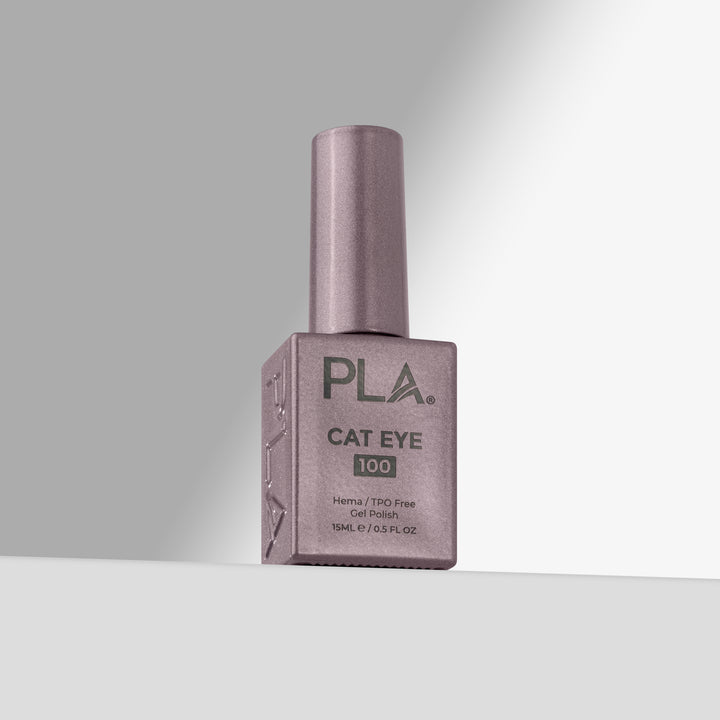 A bottle of PLA Cat Eye 100 nail polish in a lavender-purple shade, standing upright on a light gray surface against a gray background.