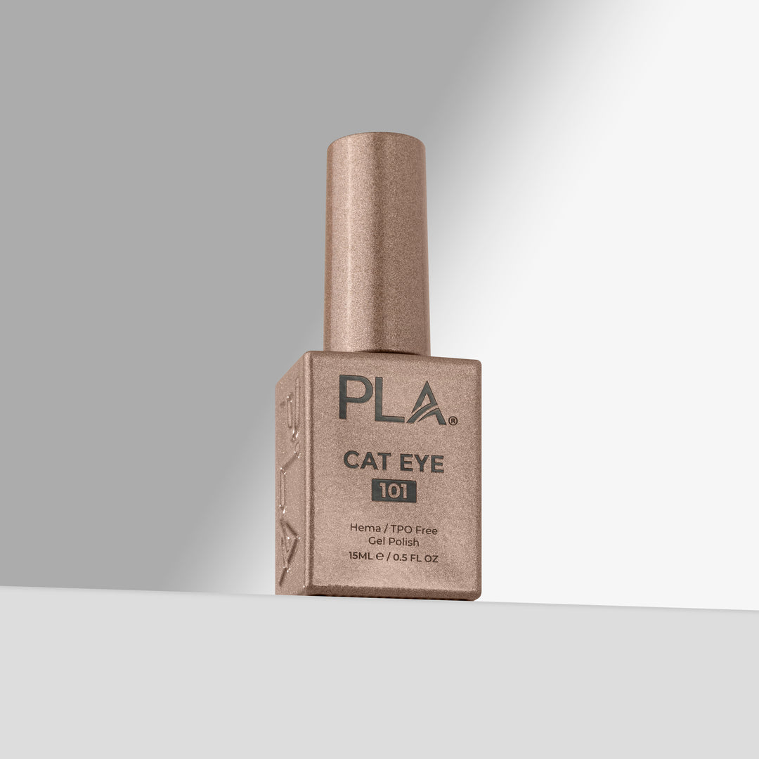 A bottle of PLA Cat Eye 101 gel nail polish in a gold shade, standing upright on a light gray surface against a white background with a soft shadow.