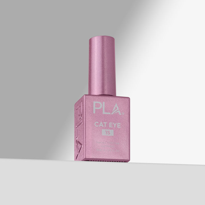 A bottle of PLA Cat Eye gel nail polish in shade 15, featuring a pink cap and a matching pink rectangular bottle with white lettering, set against a clean gray gradient background.