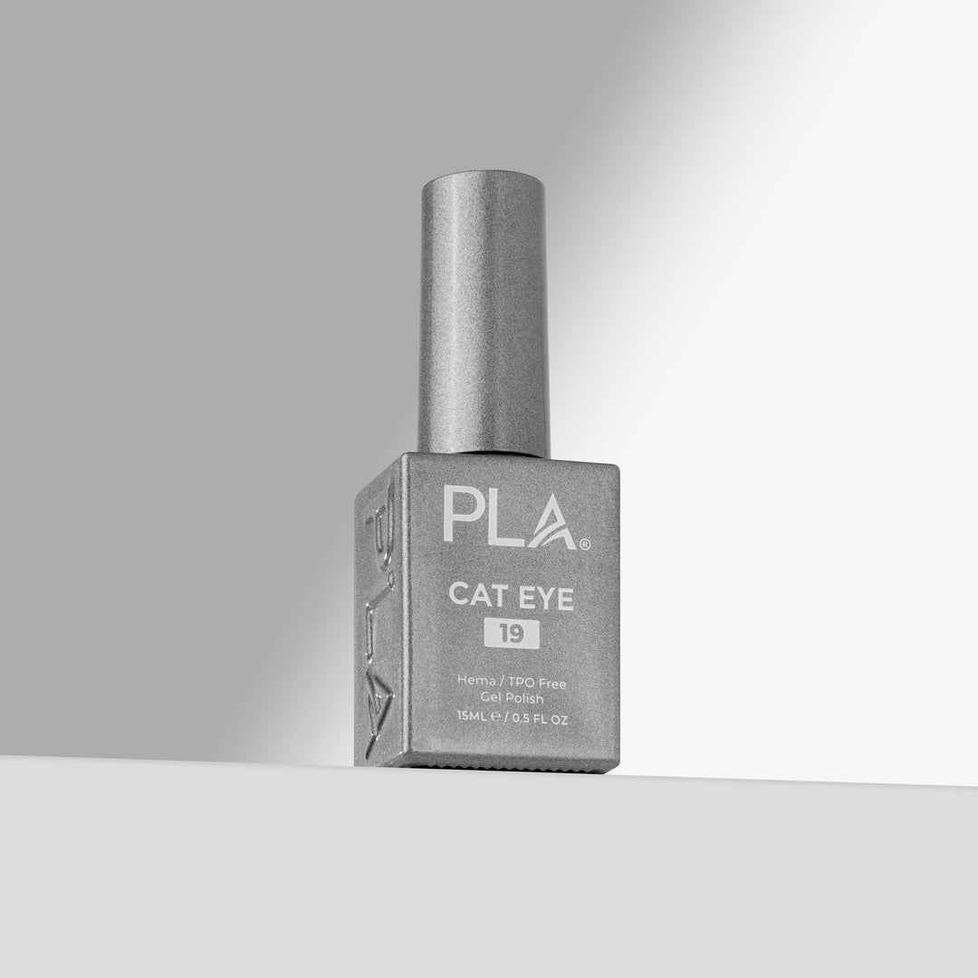 A bottle of PLA Cat Eye nail polish in shade 19, featuring a silver cap and a square silver bottle, set against a clean gray and white studio background.