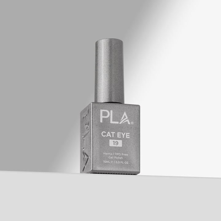 A bottle of PLA Cat Eye nail polish in shade 19, featuring a silver cap and a square silver bottle, set against a clean gray and white studio background.