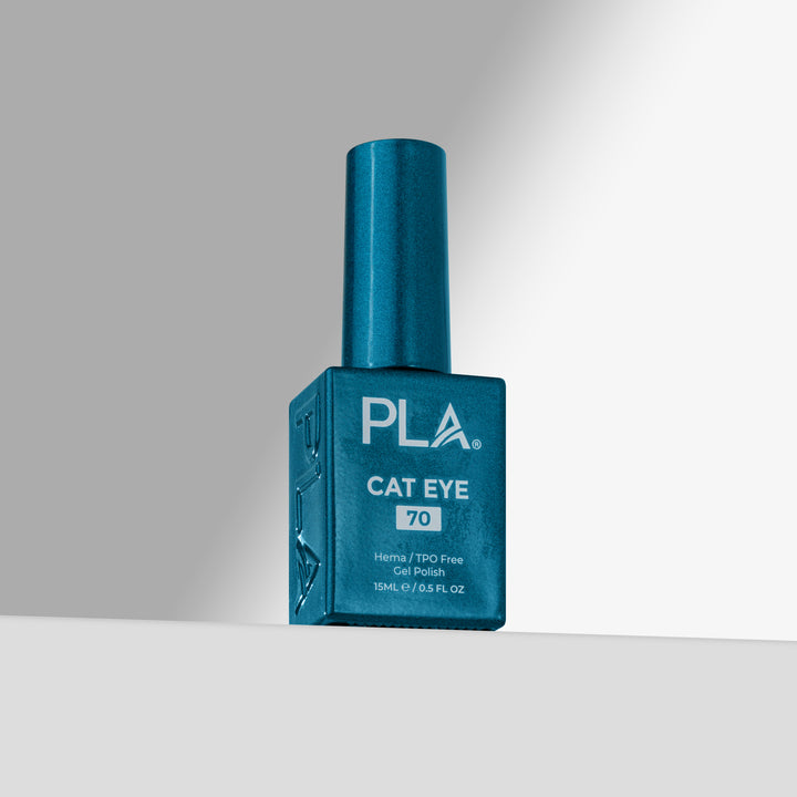 A blue bottle of PLA Cat Eye nail polish shade 70, standing upright on a light gray surface against a gray background 