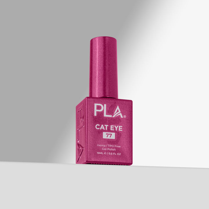 A bottle of PLA Cat Eye nail polish in shade 77, featuring a magenta-pink bottle and cap, set against a clean gray studio background 
