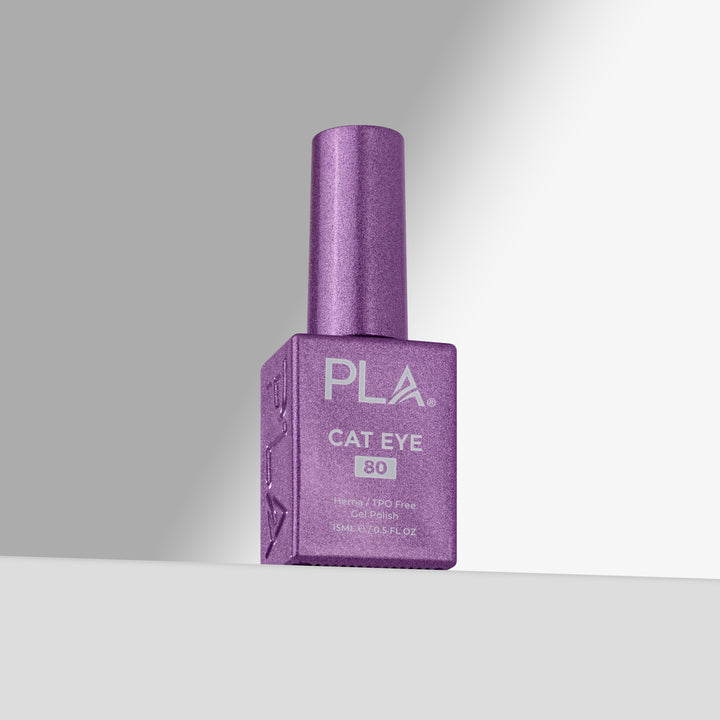 A bottle of PLA Cat Eye nail polish in shade 80, featuring a purple glitter cap and a matching purple glitter bottle with white text, set against a clean gray studio background.