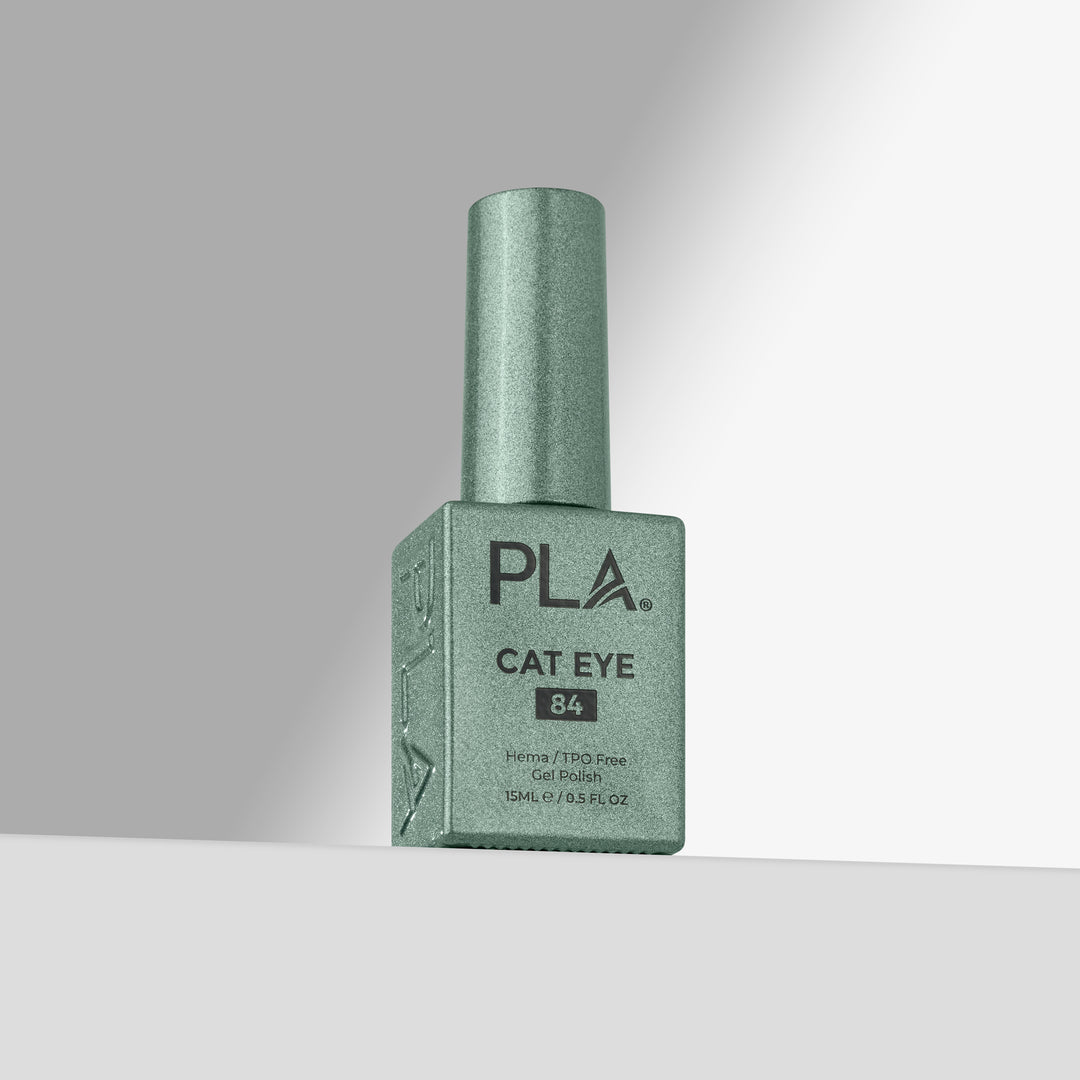 A bottle of PLA Cat Eye gel nail polish in shade 84, featuring a shimmering green cap and a matching square bottle with black text, set against a clean gray studio background.