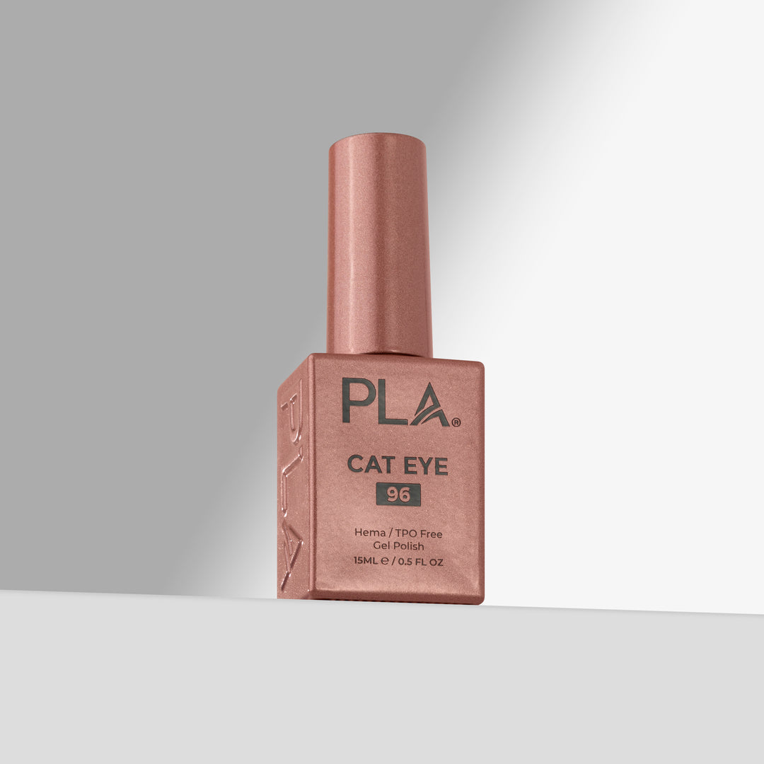 A bottle of PLA Cat Eye nail polish in shade 96, featuring a rose gold finish with a matching cap, set against a clean gray studio background.