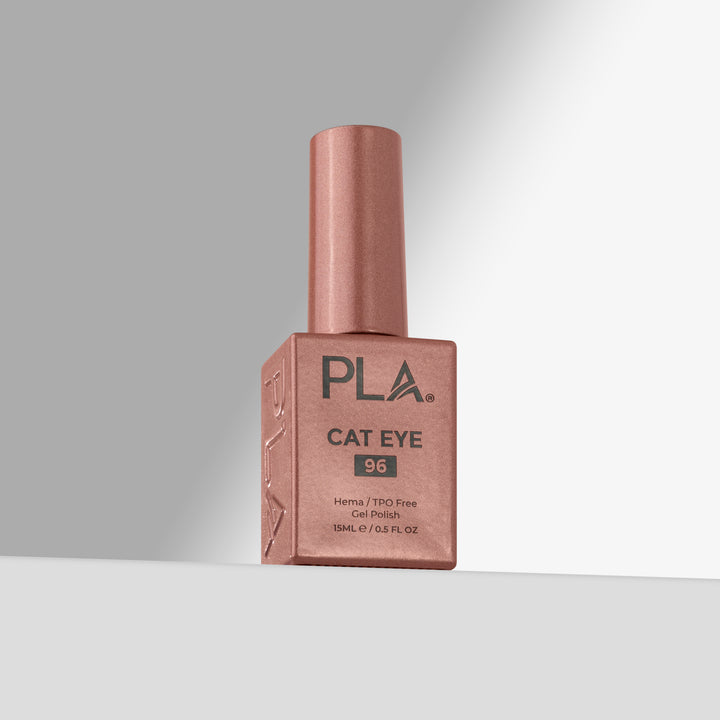 A bottle of PLA Cat Eye nail polish in shade 96, featuring a rose gold finish with a matching cap, set against a clean gray studio background.