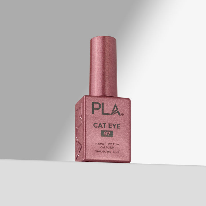 A bottle of PLA Cat Eye gel nail polish in shade 97, featuring a rose cap and a matching pink bottle with black text, set against a clean gray studio background.
