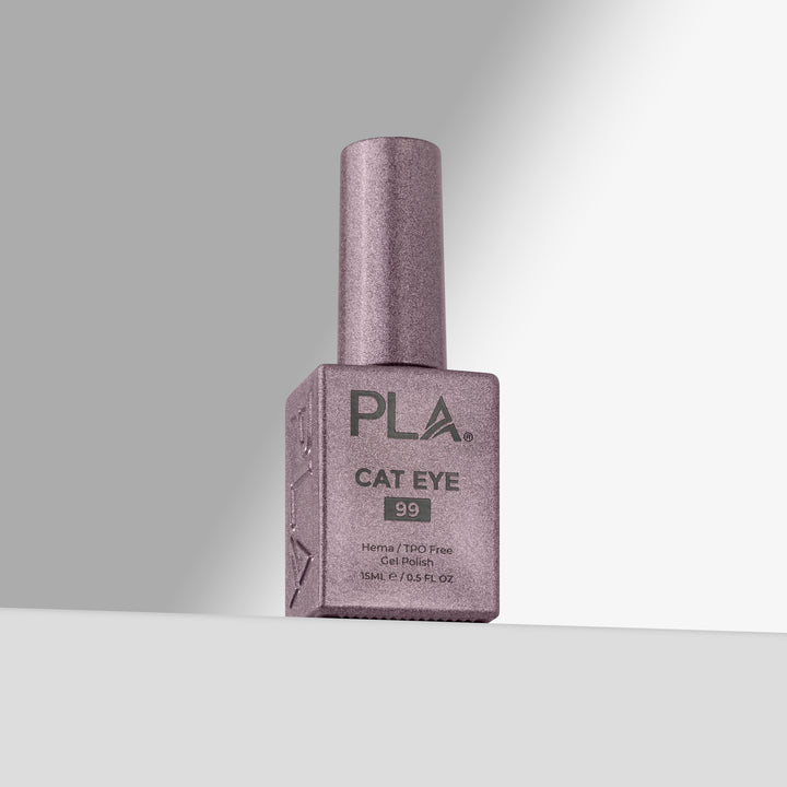 A bottle of PLA Cat Eye nail polish in shade 99, featuring a shimmering  lavender-pink color with a matching cap, set against a clean gray studio background.