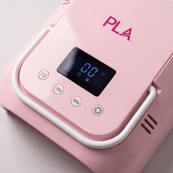 Close-up of a Pink and white Nail Light device with a glossy finish, featuring four circular buttons labeled 60s, 30s, Flash Cure, and a central screen displaying blue icons, set against a white background.
