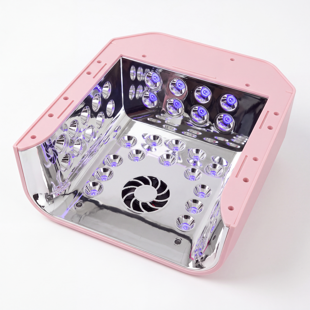 The underside of the PLA Pink Hybrid Nail Lamp: a square white and silver LED light therapy panel with multiple rows of glowing blue-purple LEDs, a central fan grille, and a reflective interior, shown on a white background.
