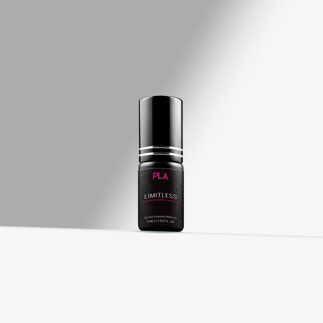 Black bottle with silver cap labeled 'Limitless' on a gray background 