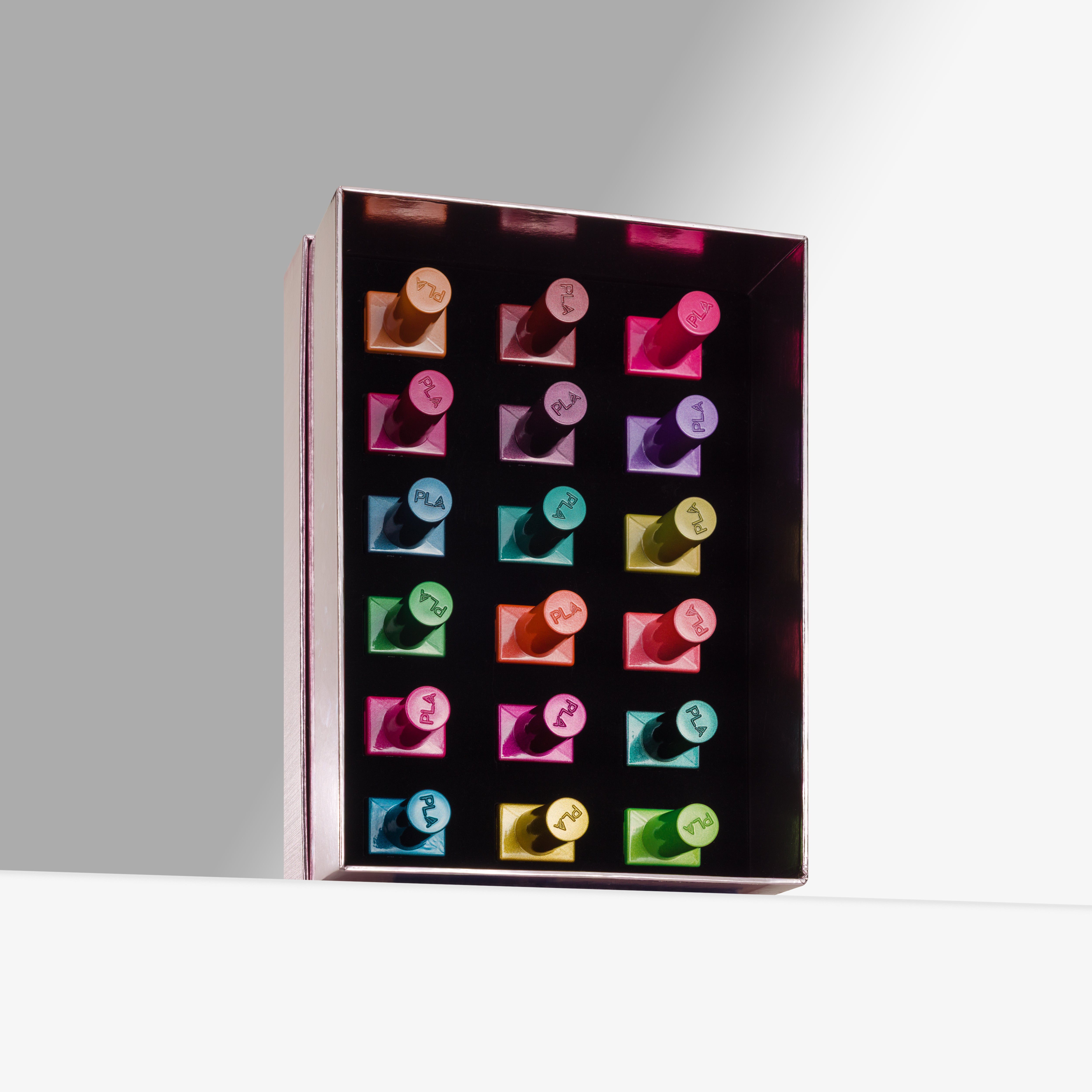 A rectangular pink box displaying 18 colorful cat eye gel nail polishes arranged in a grid, photographed on a clean white surface against a light gray background.