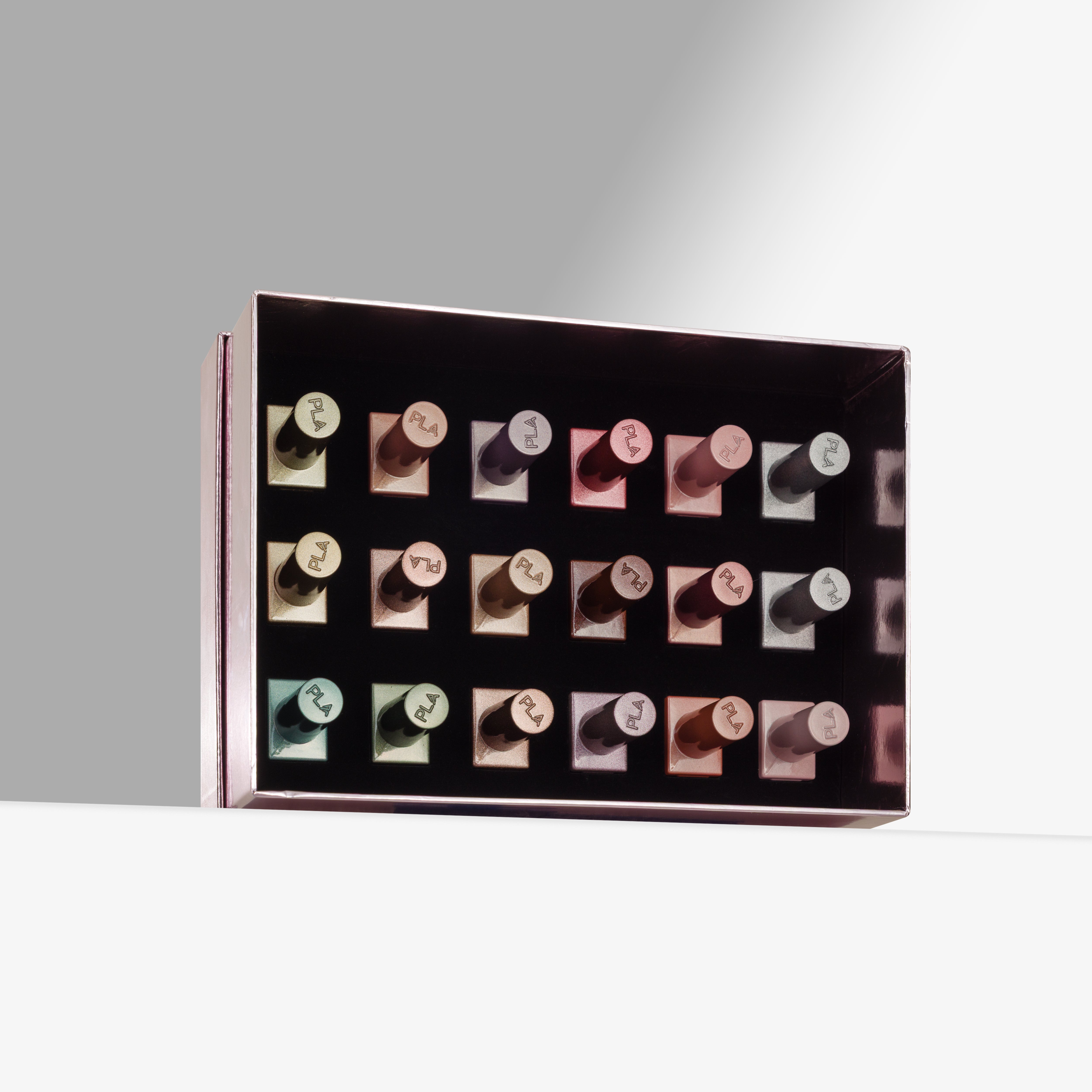 A rectangular open box containing multiple cat eye gel nail polishes arranged in rows, photographed on a clean white surface against a light gray background.