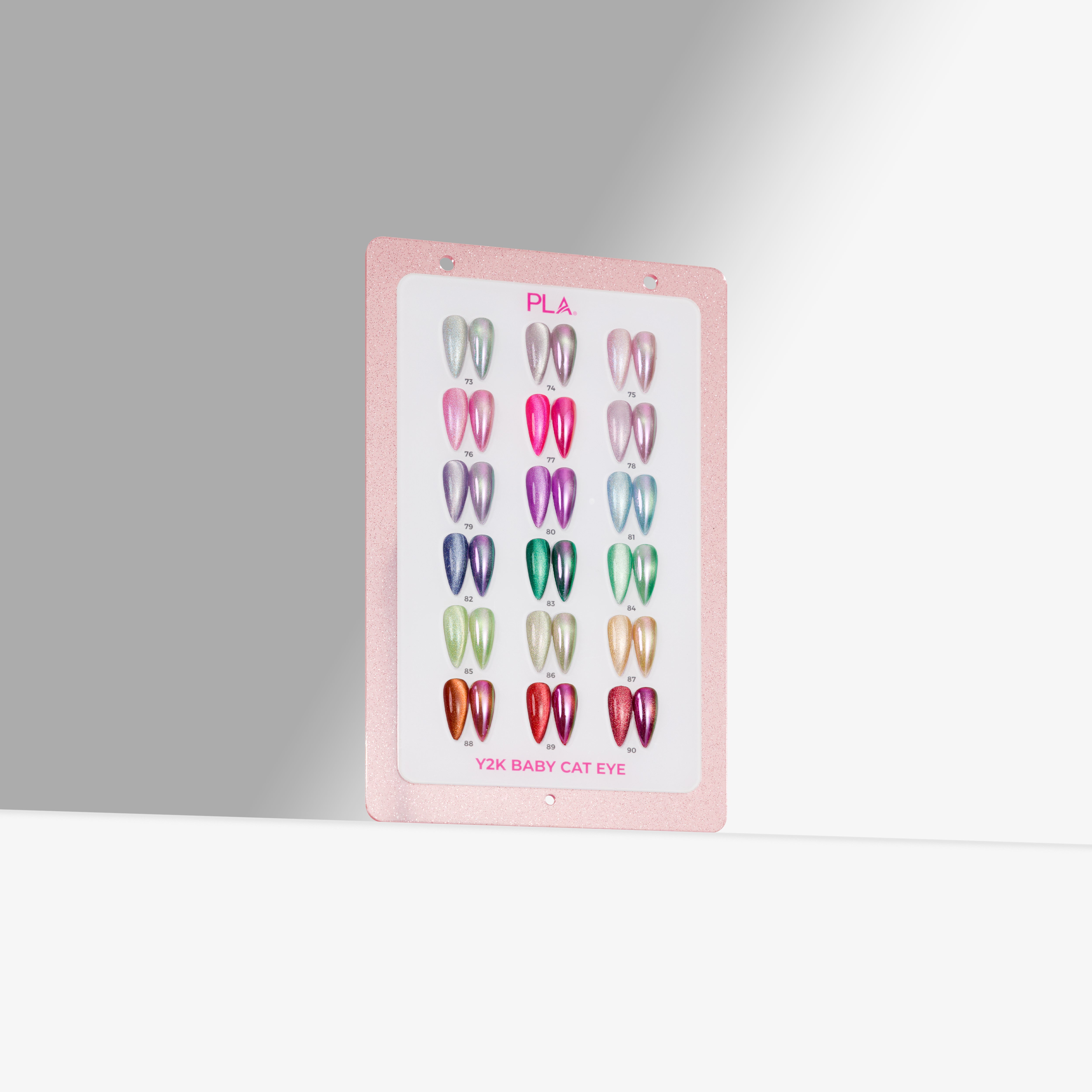 A pink swatch showing multiple cat eye nail polish nail tip swatches arranged in a grid, photographed against a clean light gray studio background.