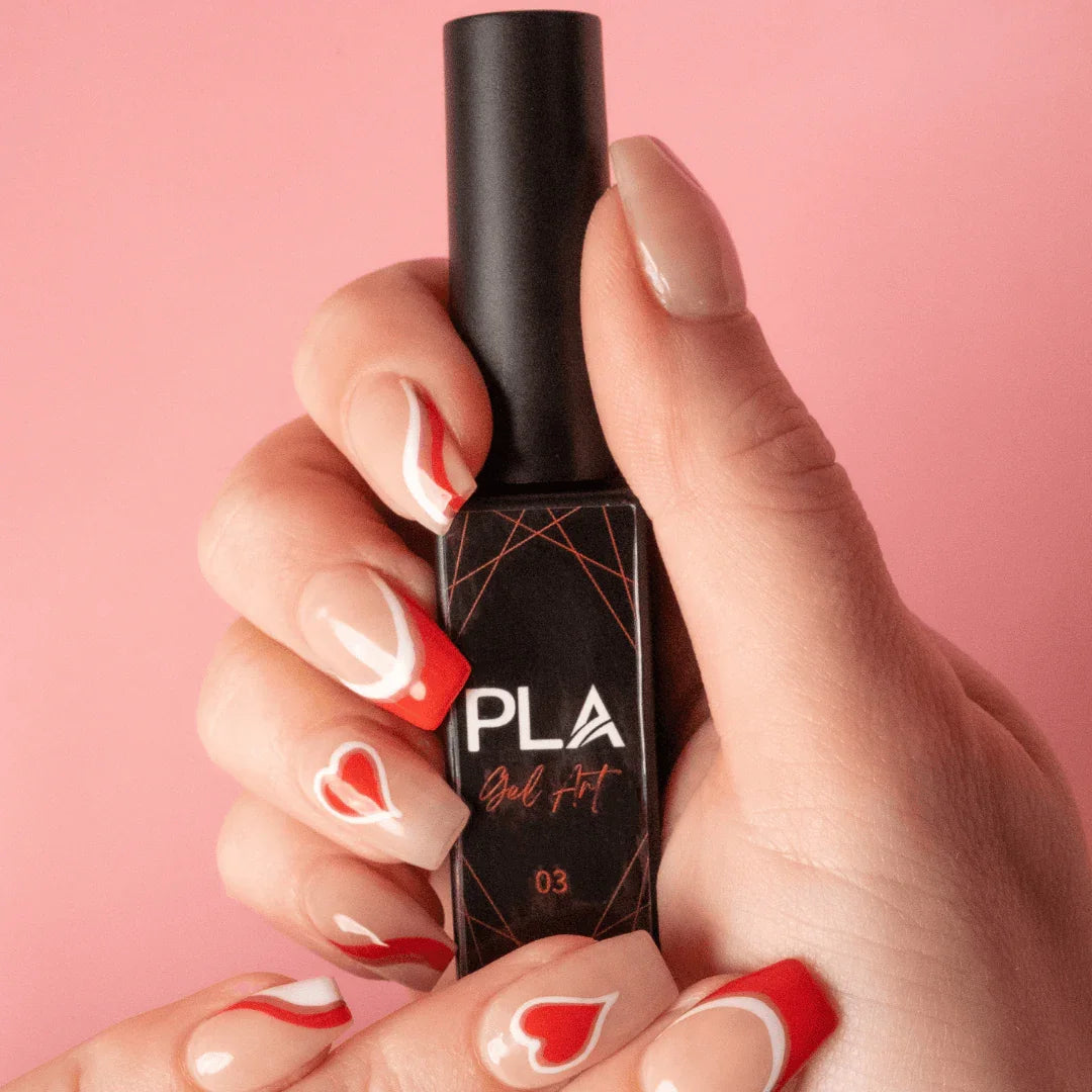 Nail set using PLA Gel Liners from Paris Lash Academy (red and white heart nail set, front view holding bottle)