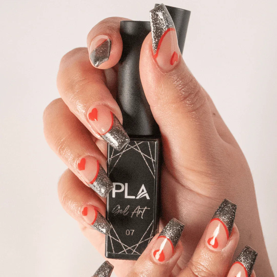 Nail set using PLA Gel Liners from Paris Lash Academy (red and silver black french tip with hearts nail set, front view holding bottle)