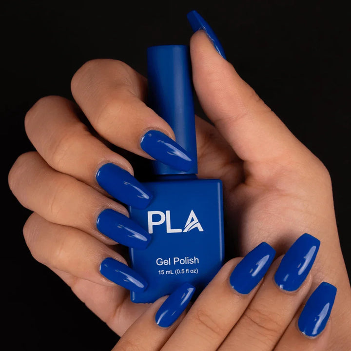 Jewel toned nail polish from PLA: Spill The Tea #185 (hands holding gel polish bottle)