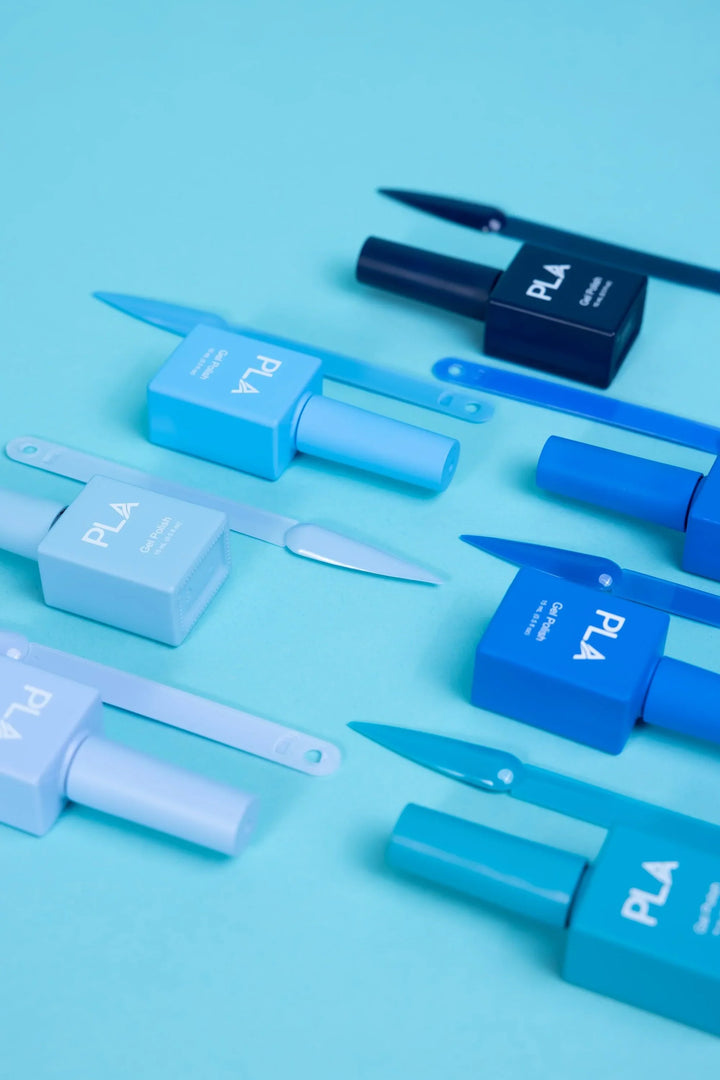 Mini nail polish sets from Paris Lash Academy — Blues (gel polishes, laying down out of box with color swatch) 