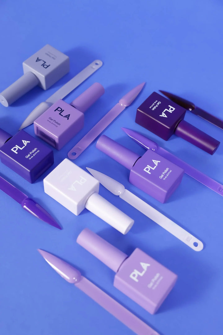 Mini nail polish sets from Paris Lash Academy — Purples (gel polishes, laying down out of box with color swatch)