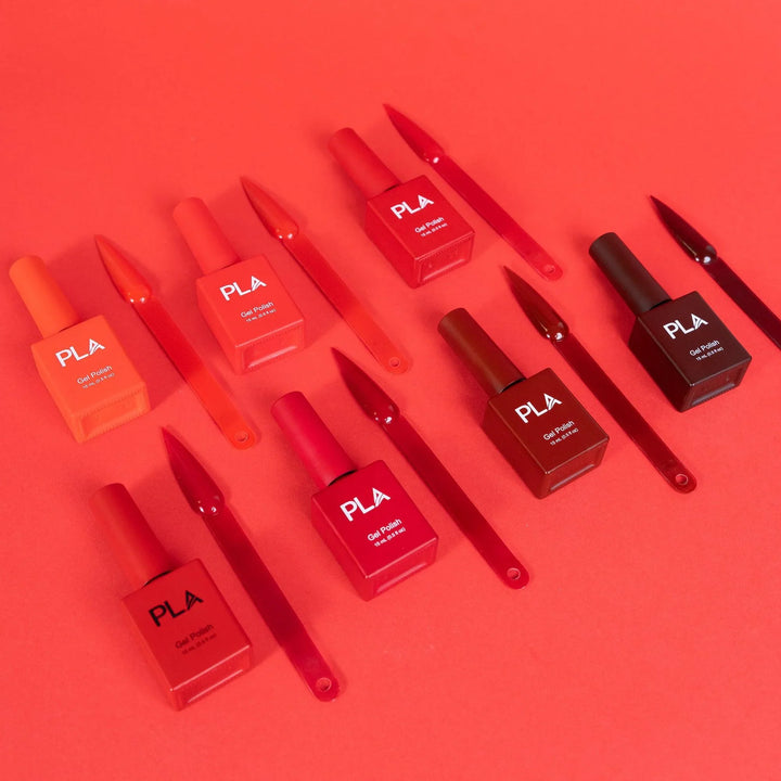 Mini nail polish sets from Paris Lash Academy — Reds (gel polishes, laying down out of box with color swatch)